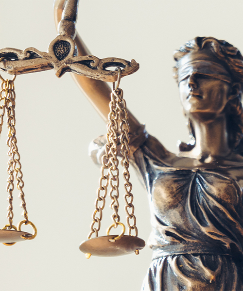 Lady Justice statue holding balanced scales