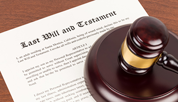 Judge’s gavel resting on a last will and testament.